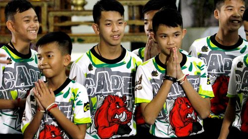 Some of the 12 members of the Wild Boars soccer team greet the media. Picture: EPA/AAP
