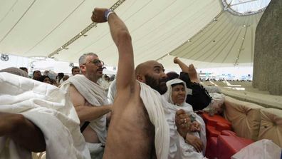Masses of pilgrims have embarked on a symbolic stoning of the devil in Saudi Arabia under the soaring summer heat.