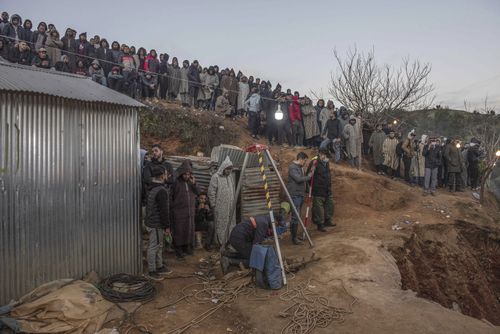 Residents watch in concern as civil defense and local authorities dig in a hill as they attempt to rescue a 5 year old boy who fell into a hole near the town of Bab Berred near Chefchaouen, Morocco, Thursday, Feb. 3, 2022. (AP Photo)