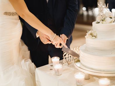 Couple cutting wedding cake