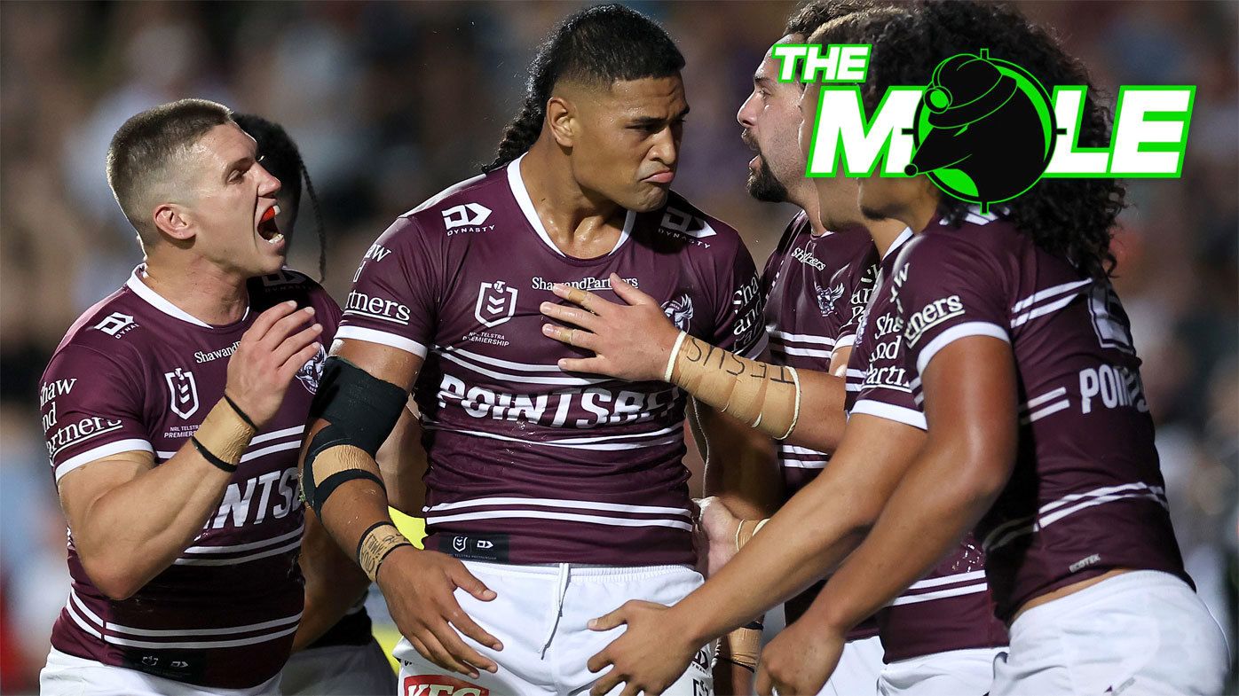 Haumole Olakau&#x27;atu is swamped by teammates as they celebrate a crucial try for Manly against the Eels.