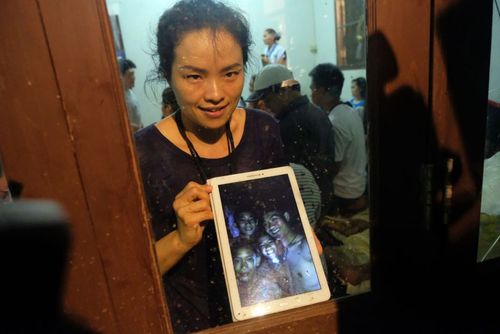 A parent of one of the rescued children shows off the selfie of the boys taken inside the cave. Picture: Getty