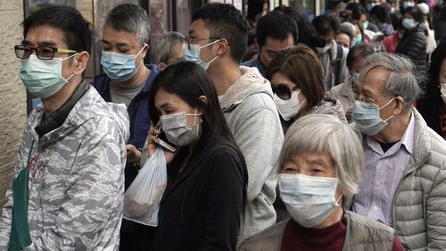 People queue up to buy face masks in Hong Kong, Friday, Feb. 7, 2020