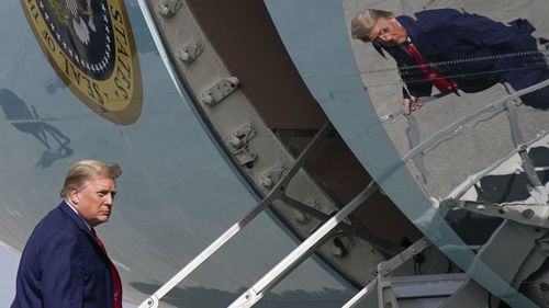 Donald Trump boards a particularly reflective Air Force One.