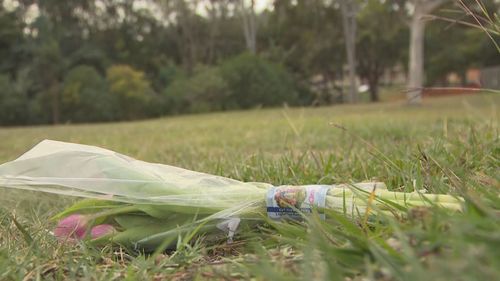 Flowers to remember a baby girl who died after a magpie swooping incident at  Glindemann Park in Holland Park West.