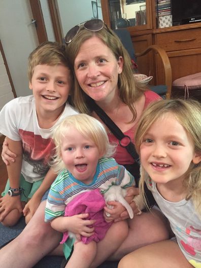 Ellen with her three children and her arm in a cast after her devastating accident.