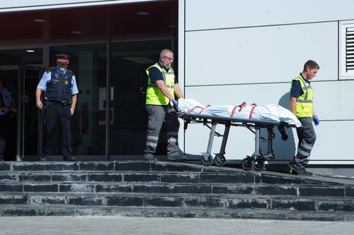  Two workers of Judicial Service remove the body of the man who entered in a police station early morning holding a knife and allegedly shouting 'Allah is great', lived in the town Cornella de Llobregat, in Barcelona, northeastern Spain