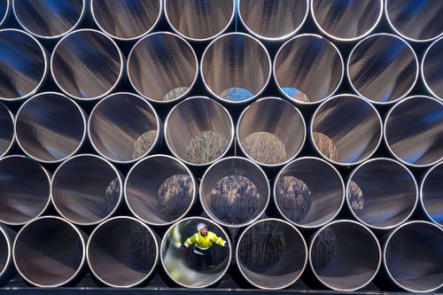 A worker crawls through pipes for the Nord Stream 2.