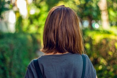 Woman photo from back of short bob hair style. Healthy hair cut, hair care and beauty concept