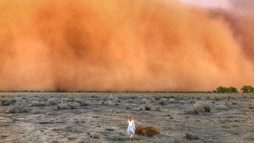 A nine-year-old girl running towards an apocalyptic dust storm in Nyngan, in Central NSW.