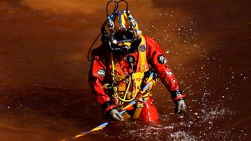 A diver walks out from a toxic man-made lake after a dive search for a third victim near the village of Mitsero outside of the capital Nicosia, Cyprus. Army captain Nicholas Metaxas was sentenced to seven life terms after he pleaded guilty to the premeditated murder and kidnapping of seven foreign women and girls. 