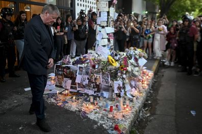 Geoff Payne, left, the father of former One Direction singer Liam Payne, visits a memorial outside the Casa Sur Hotel where the British pop singer fell to his death from a hotel balcony, in Buenos Aires, Argentina, Friday, Oct. 18, 2024. (AP Photo/Mario De Fina)