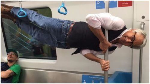 Groovy grandpa refuses ‘elderly seat’ on Rio train and performs impressive pole lift instead