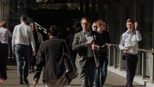 Pedestrians and office workers walk through the Sydney CBD.