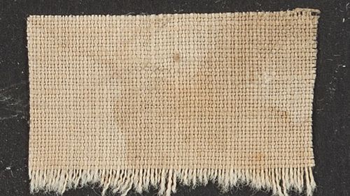 A blood-stained piece of linen from Lincoln's death bed that sold for $6000. (AAP)