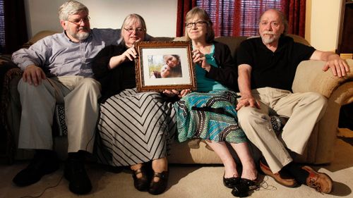 Patrick Boyle, Linda Boyle, Lyn Coleman and Jim Coleman hold photo of their kidnapped children, Joshua Boyle and Caitlan Coleman. (AAP)
