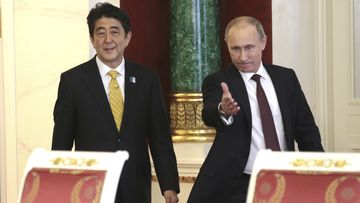 Russian President Vladimir Putin, right, and visiting Japanese Prime Minister Shinzo Abe walk in a hall to take part in a final news conference in Moscow&#x27;s Kremlin, Monday, April 29, 2013. 