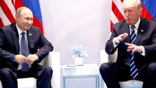 Vladimir Putin and Donald Trump sit for their first face-to-face meeting. (AAP)