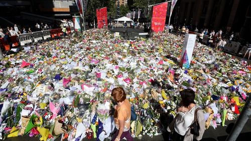 Martin Place was flooded in a sea of colour as people shared in their grief for the victims and hostages of the Lindt cafe siege. (AAP)