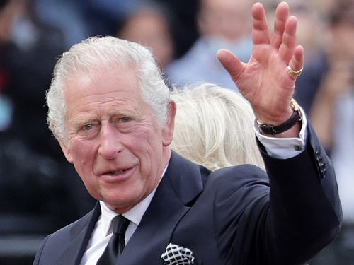 LONDON, ENGLAND - SEPTEMBER 09:  King Charles III waves to the public after viewing floral tributes to the late Queen Elizabeth II outside Buckingham Palace on September 09, 2022 in London, United Kingdom. Elizabeth Alexandra Mary Windsor was born in Bruton Street, Mayfair, London on 21 April 1926. She married Prince Philip in 1947 and acceded the throne of the United Kingdom and Commonwealth on 6 February 1952 after the death of her Father, King George VI. Queen Elizabeth II died at Balmoral Ca