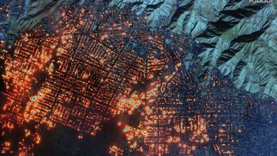 A satellite image shows the Eaton wildfire has set nearly every building in western Altadena in Los Angeles on fire.