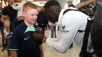 Thomas Deng of the Socceroos meets with fans at Melbourne Airport.