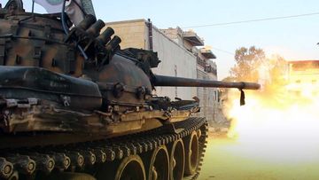 A tank from the Al-Qaeda-linked Hay'at Tahrir al-Sham fires a shot in the city of Idlib.