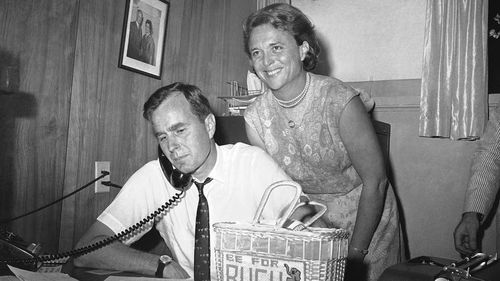 Barbara Bush stands over the shoulder of her husband George during his unsuccessful 1964 Senate bid. (AAP)