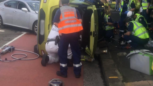 A car flipped on its side during the crash in Sydney. 