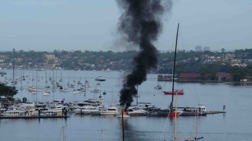 A reader image of the boat on fire at the marina in Drummoyne.