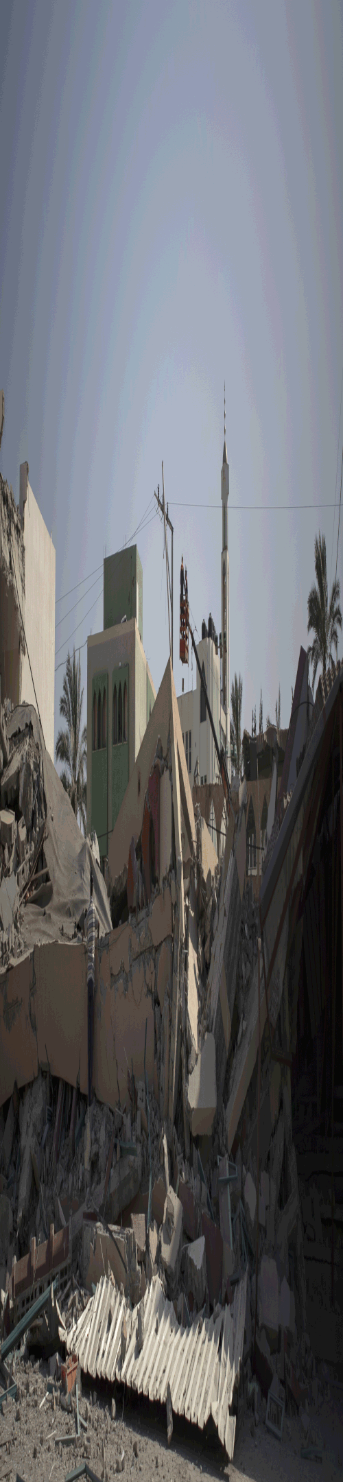 Palestinians inspect the damage following Israeli airstrikes that destroyed a building belonging to the Hamas movement's, Al-Salah Charitable Association, in Deir Al Balah, central Gaza Strip.