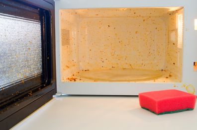 Open microwave. Dirt from food inside. Close up