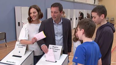 Matthew Guy casts a ballot with his family.