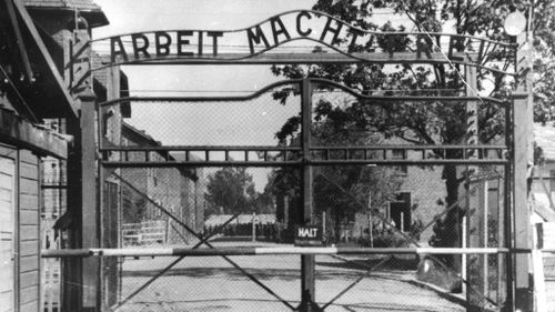 Writing at the gate of Auschwitz reads: "Arbeit macht frei", which translates to "Work Makes Free". (AAP) 