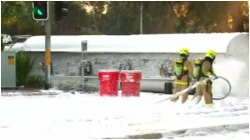 HAZMAT crews used foam to smother fuel after a truck overturned yesterday morning. (9NEWS)