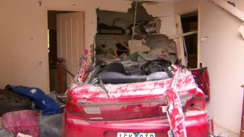 The red Mazda smashed into The Promenade home about 7.20am. (9NEWS)