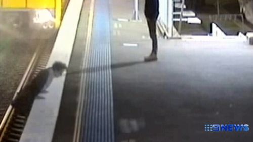 The man narrowly escapes death as an oncoming train just misses hitting him. (9NEWS)