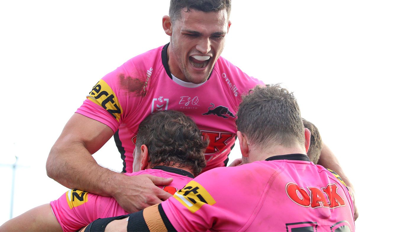 Nathan Cleary of the Panthers jumps on top of his teammates as they celebrate a try 