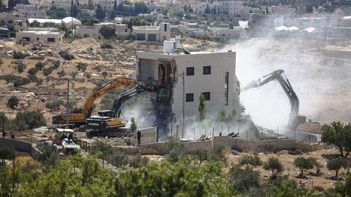 Israeli bulldozers demolish a Palestinian house in the village of Marah Ma'ala, south of Bethlehem in the occupied West Bank, July 13.