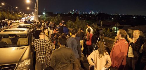 Revellers taking to a vantage point to watch the fireworks display. (Image: AAP)