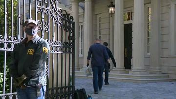 FBI agents are shown here at the Washington home of Russian oligarch Oleg Deripaska.