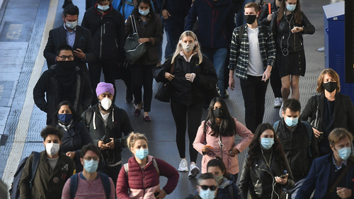 Commuters at Waterloo Station, in London, at 08:54hrs on Thursday, after Prime Minister Boris Johnson announced a range of new restrictions to combat the rise in coronavirus cases in England. Victoria Jones/PA Wire