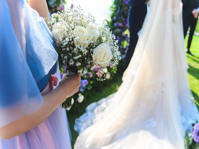 Maid of honour standing next to bride at wedding