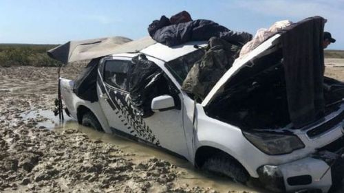 The men were forced to sleep on the roof of their bogged Holden Colorado. (Supplied)