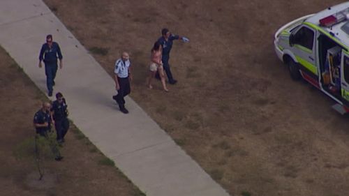 Police assist a woman at the scene of the disappearance. (9NEWS)