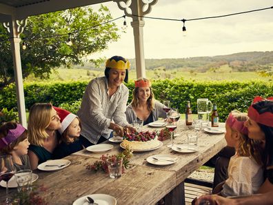 Family eating Christmas lunch on verandah