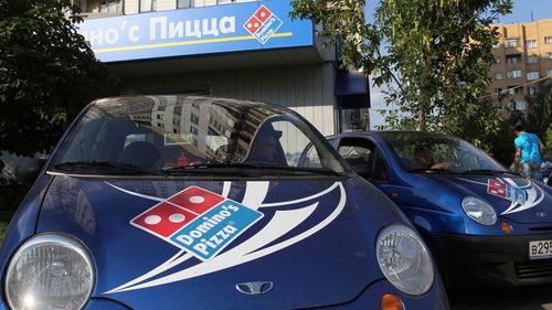 Delivery vehicles stand outside a Domino's Pizza store in Moscow