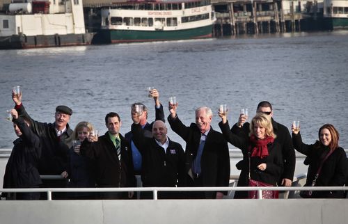 Captain Chesley "Sully" Sullenberger III (fourth from right) joins survivors and rescuers in a toast marking the fifth anniversary of the miracle landing.