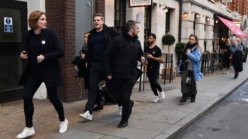 People hurriedly leave the area after reports of shots being fired on London Bridge on November 29, 2019