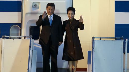 China's President Xi Jinping and first lady Peng Liyuan arrive at the Ministro Pistarini international airport in Buenos Aires.